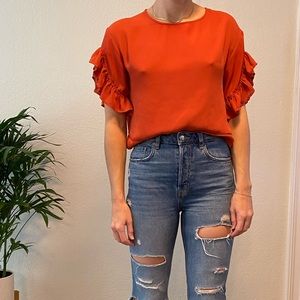 Burnt orange top with ruffle sleeve detail